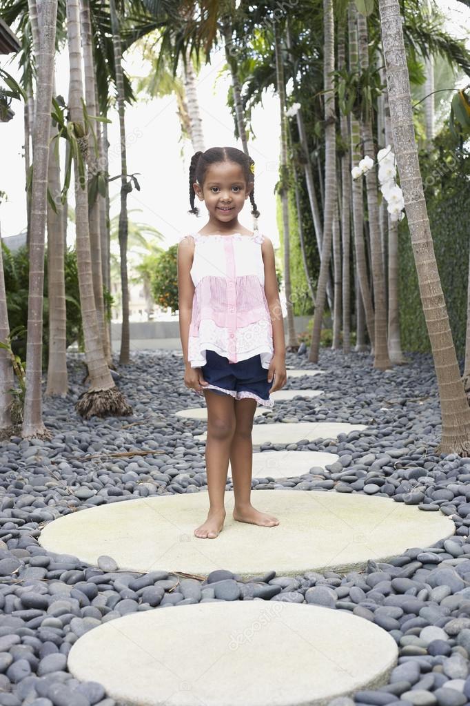 Girl  standing on stepping stone