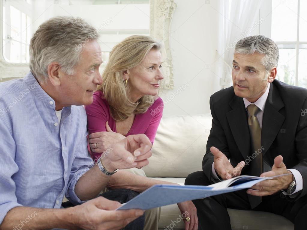 Couple sitting on sofa with financial advisor