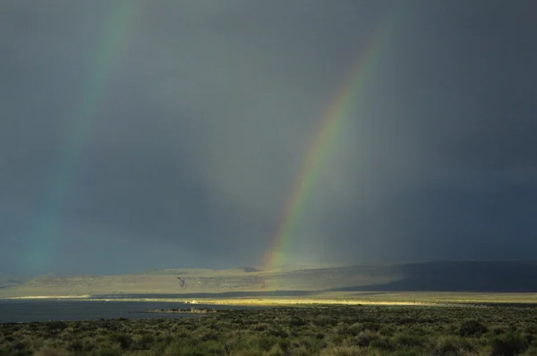 Rainbow over lake — Stock Photo, Image