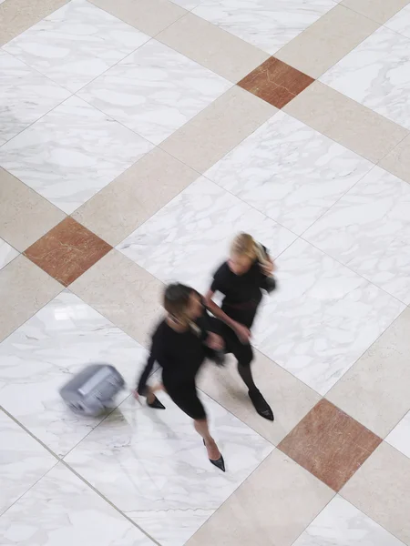Business women walking with suitcase