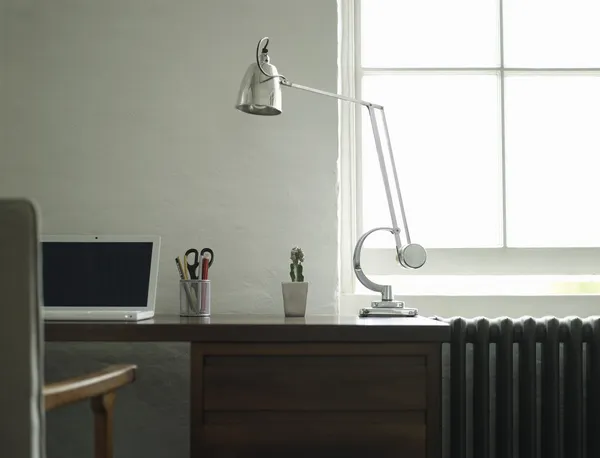 Desk with laptop and lamp — Stock Photo, Image