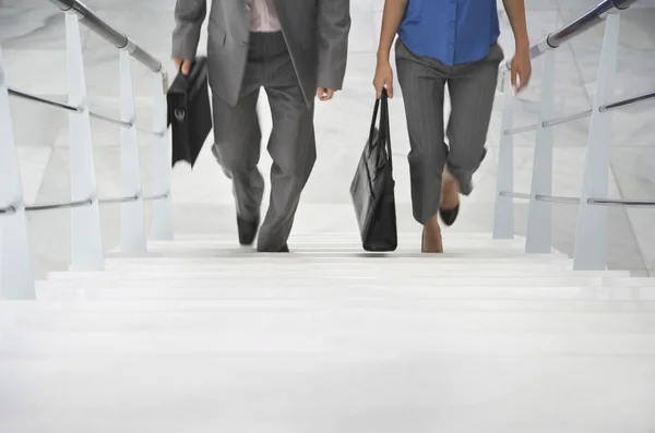 Business people walking up stairs — Stock Photo, Image