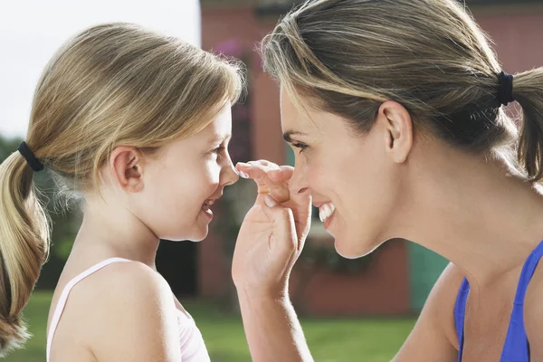 Moeder toepassing van zonnebrandcrème — Stockfoto