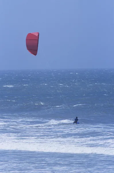 Person kitesurfing in sea — Stock Photo, Image