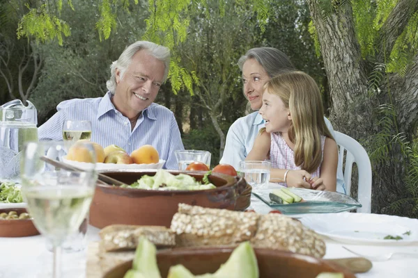 Grandparents sitting at table — Stock Photo, Image