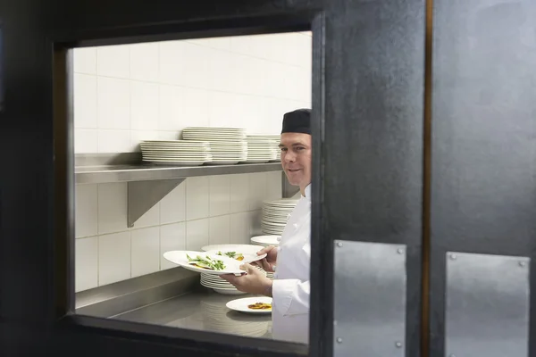 Man chef holding plates — Stock Photo, Image