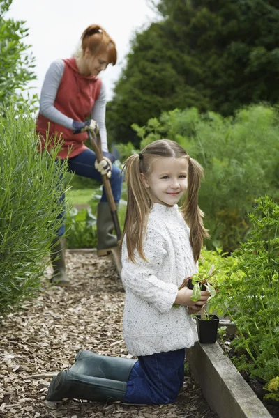 Girl gardening with mother — Stock Photo, Image