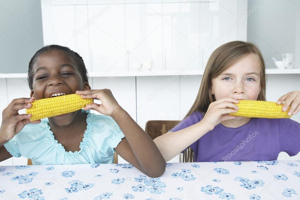 Girls Eating Corn Cobs