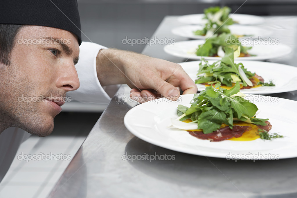 Male chef preparing salad