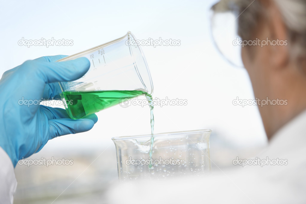 Technician Pouring Blue-green Liquid