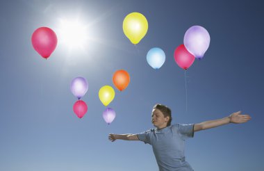 Boy Releasing Balloons clipart