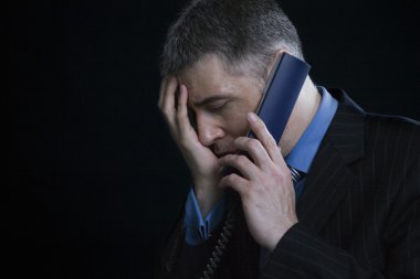 Businessman using landline phone clipart