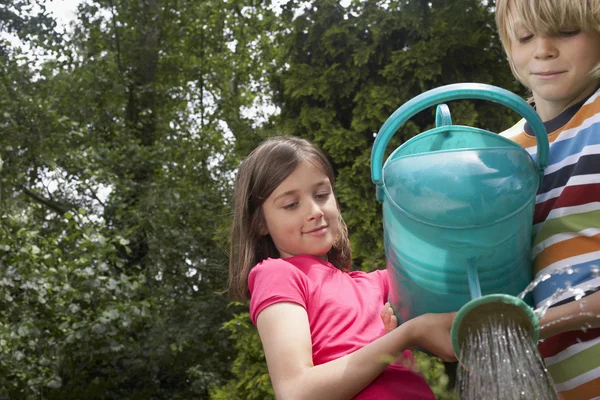 Boy and Girl with Watering Can — Stock Photo, Image