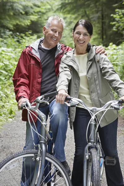 Man and middle-aged woman on bicycles — Stock Photo, Image