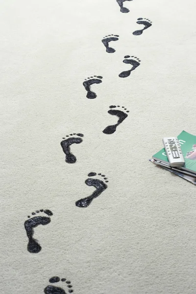 Black footprints on carpet — Stock Photo, Image