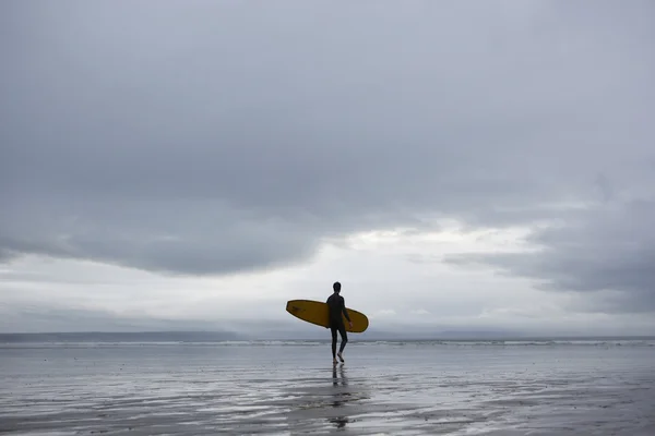 Surfeur portant une planche de surf — Photo