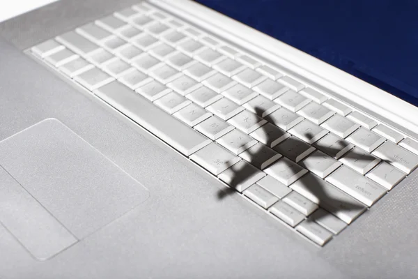Shadow of jumbo jet over keyboard — Stock Photo, Image