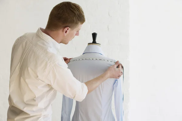 Tailor measuring blouse hanging — Stock Photo, Image