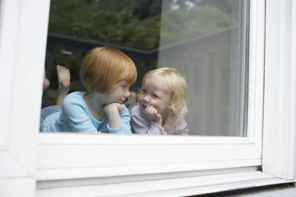 Kleine Schwestern im Fenster — Stockfoto