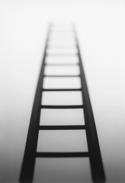 Ladder leading to light source — Stock Photo, Image