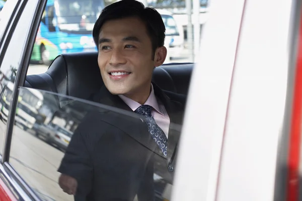 Businessman looking out of window — Stock Photo, Image