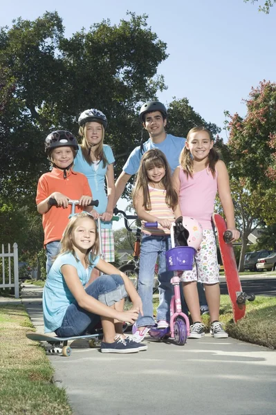 Children with scooters and skateboard — Stock Photo, Image