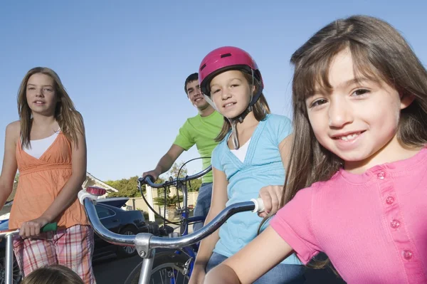 Children with scooters and bicycle — Stock Photo, Image