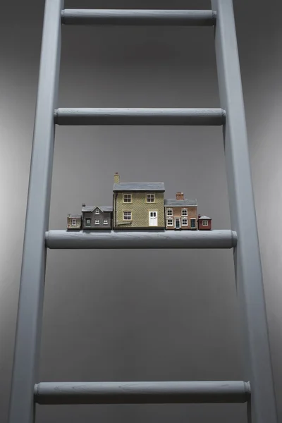 Small model houses on ladder — Stock Photo, Image