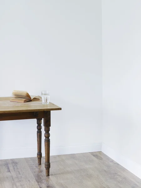 Glass of water and open book — Stock Photo, Image