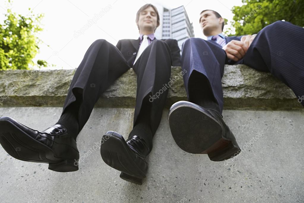Two businessmen sitting side by side