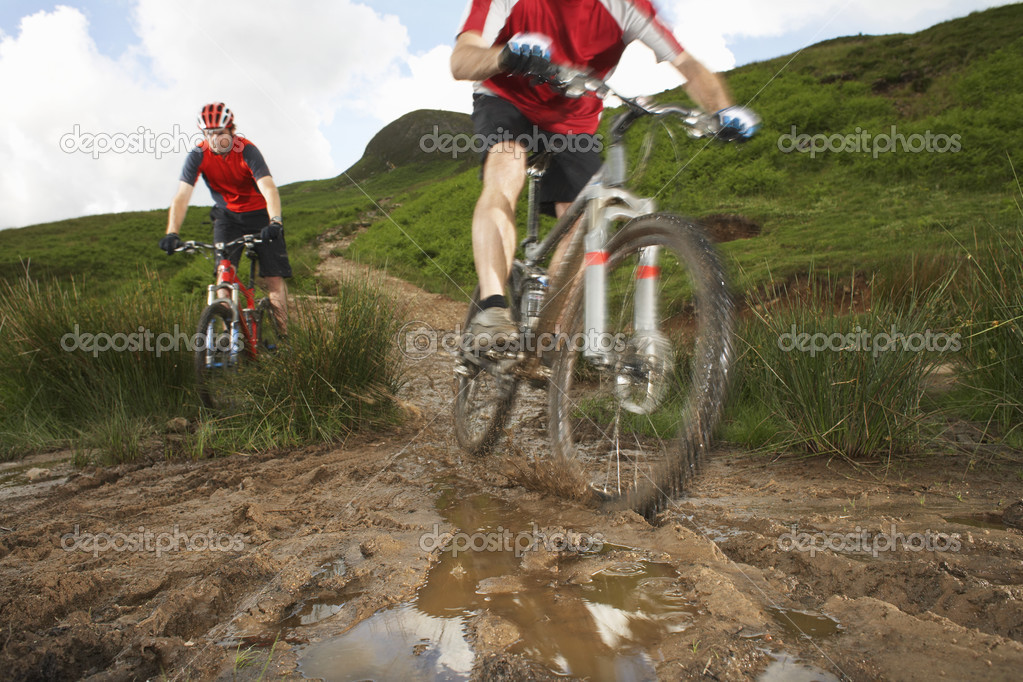 Mountainbikers on a Muddy Trail