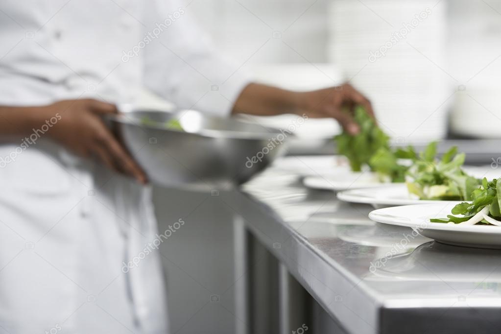 Chef preparing salad in kitchen