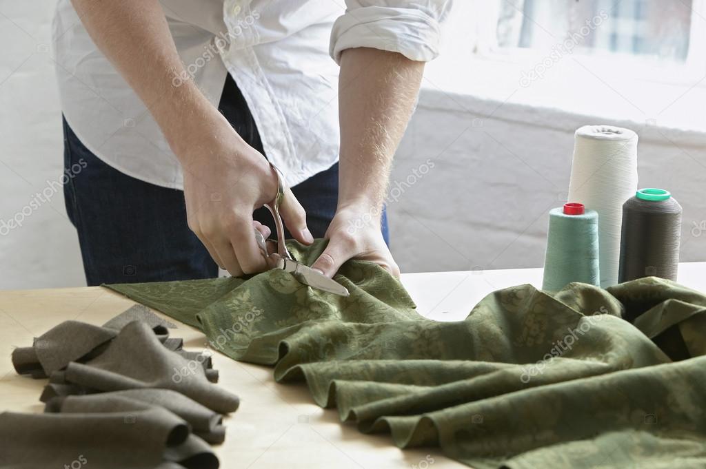 Tailor cutting fabric
