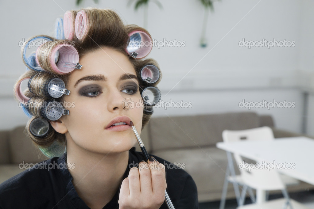 Model Applying Lip Gloss — Stock Photo © londondeposit 33888723