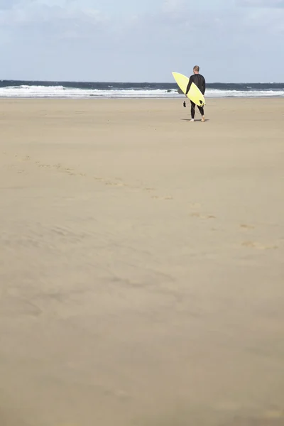 Homme portant une planche de surf — Photo