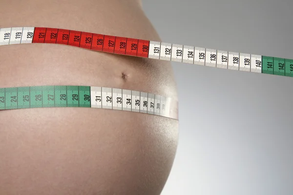 Pregnant woman with tape measure — Stock Photo, Image