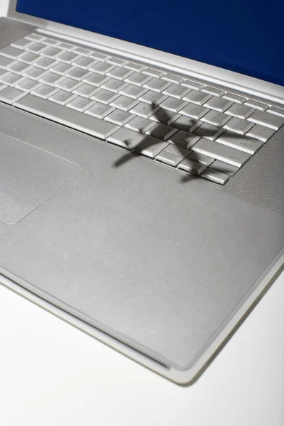 Shadow of jumbo jet over keyboard — Stock Photo, Image