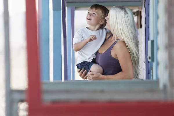 Beautiful mother holding son on porch — Stock Photo, Image