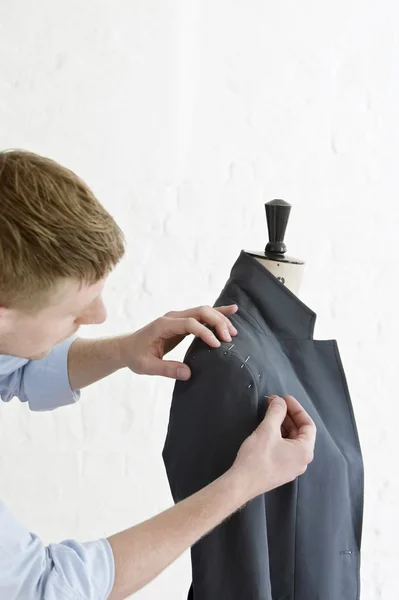 Tailor pinning sleeve to jacket — Stock Photo, Image