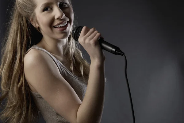 Woman singing in studio