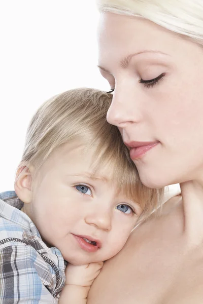 Mother cuddling son — Stock Photo, Image