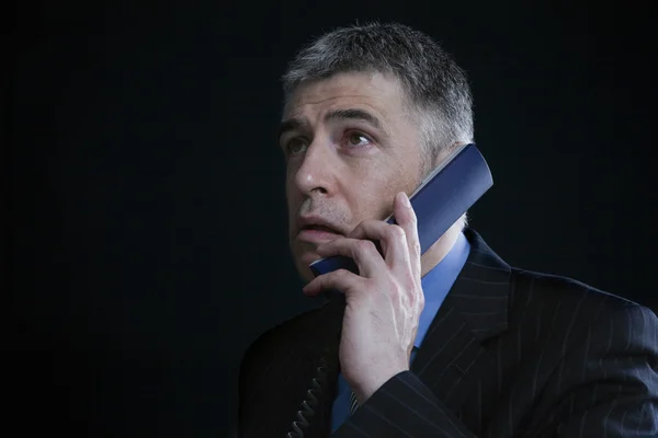 Businessman using landline phone — Stock Photo, Image