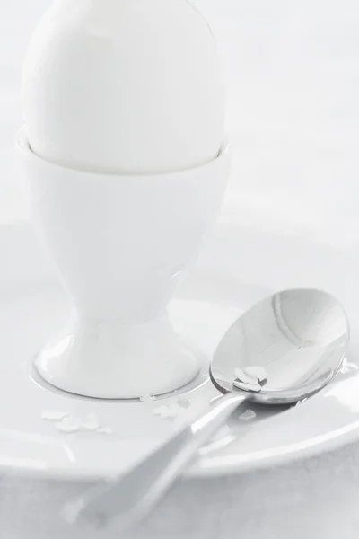 Egg in egg cup on saucer — Stock Photo, Image