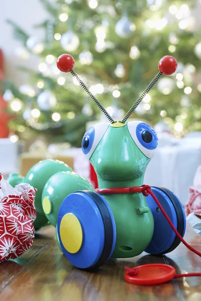 Toy alien in front of Christmas tree — Stock Photo, Image