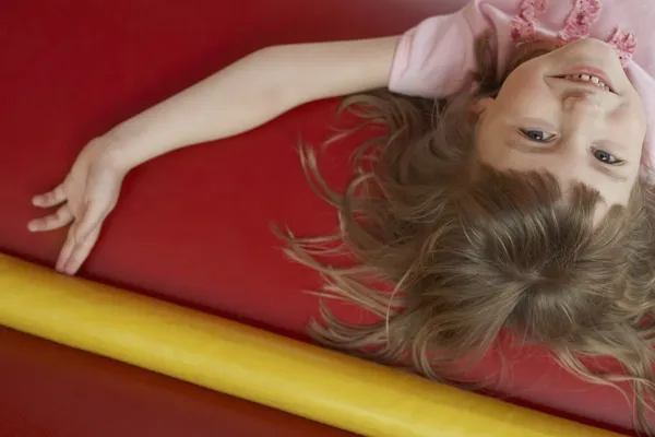 Menina deitada no castelo bouncy — Fotografia de Stock