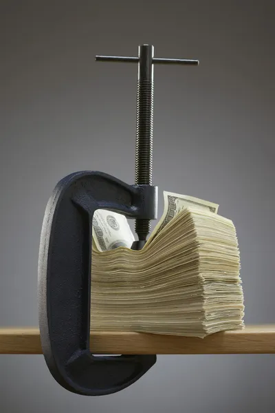 Vise gripping stack of banknotes — Stock Photo, Image