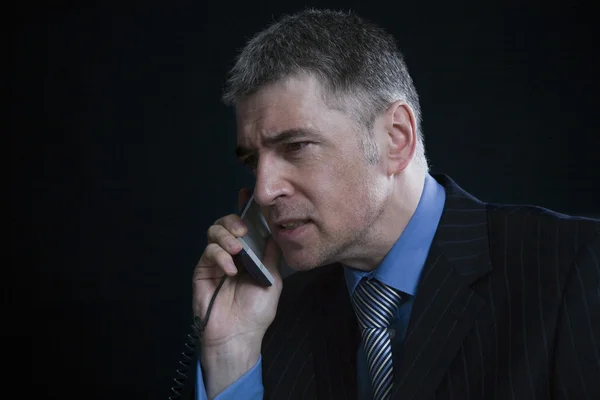 Businessman using landline phone — Stock Photo, Image