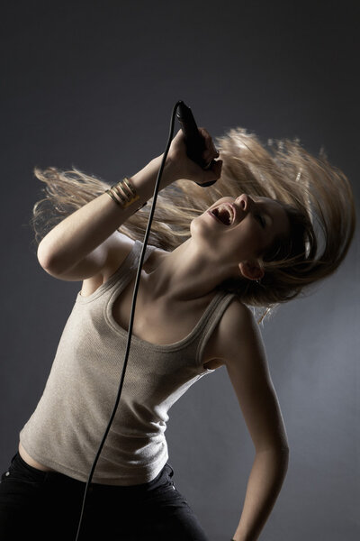 Woman singing in studio