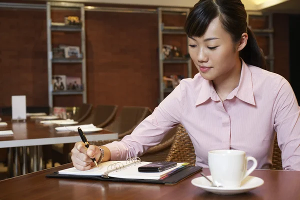 Woman Writing in Daily Organizer — Stok Foto