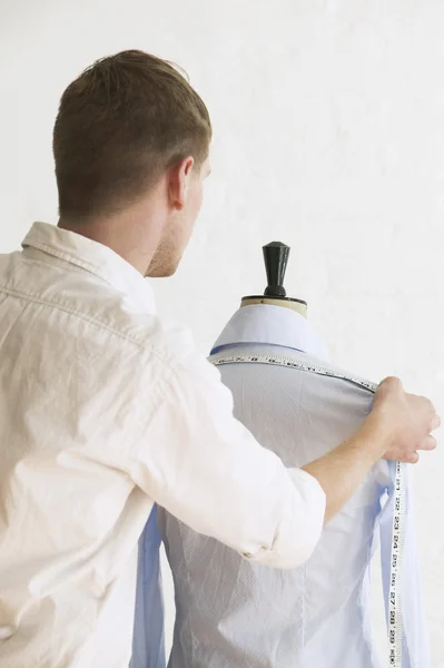 Tailor measuring blouse hanging — Stock Photo, Image